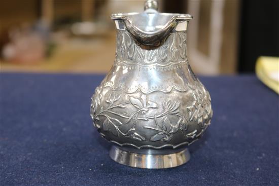 A Chinese cream jug and a small group of mixed metal items.